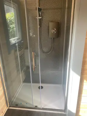 a shower with a glass door in a bathroom at Loch View Luxury Pod in Connel