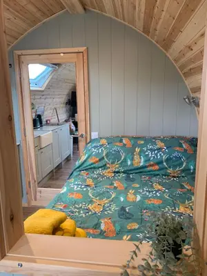a bedroom with a bed in a small room at Tawny Owl Pod with Hot Tub in Oban