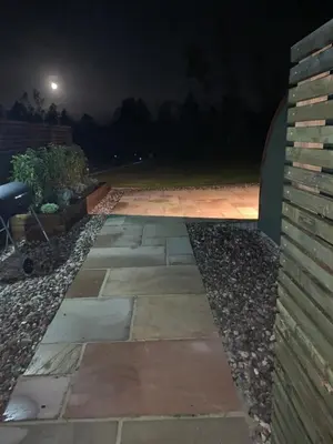 a walkway in a garden at night at Tawny Owl Pod with Hot Tub in Oban