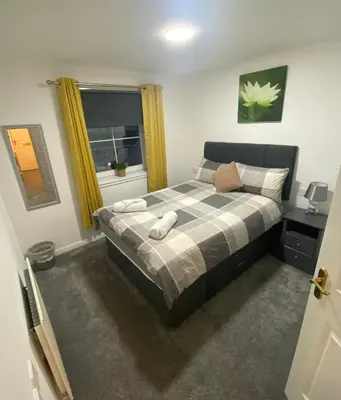 a bedroom with a bed and a window at Prime Duloch Bridge View by TBA in Dunfermline