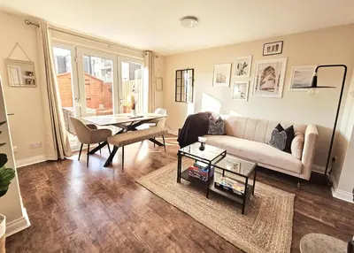 a living room with a couch and a table at Modern 5 Bedroom Townhouse with Free Parking in Glasgow