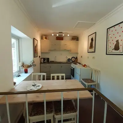 a kitchen with a table and chairs in a room at Peaceful and Stunning Waterside Location in Helensburgh