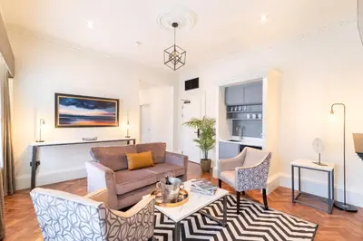 a living room with a couch and chairs at King Street Aparthotel in Stirling