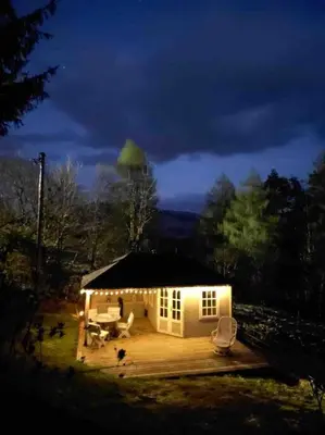 a small house with a grass roof with a tree on top at Scottish Highland Cottage Tyndrum Upper Station in Crianlarich