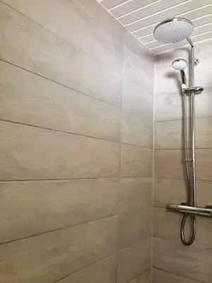 a shower with a shower head in a bathroom at Stringy Rocks in Morenish