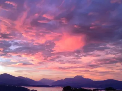 a cloudy sky with mountains and a body of water at Holiday Home Lorn Mill-2 by Interhome in Balloch