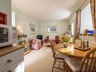 a kitchen and a living room with a table at Holiday Home Lorn Mill-2 by Interhome in Balloch
