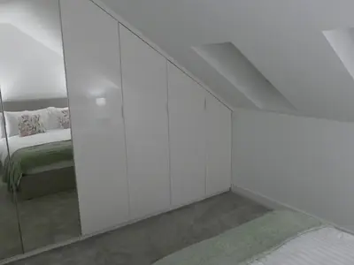 a white room with a bed and a mirror at The Annexe in Eaglesham