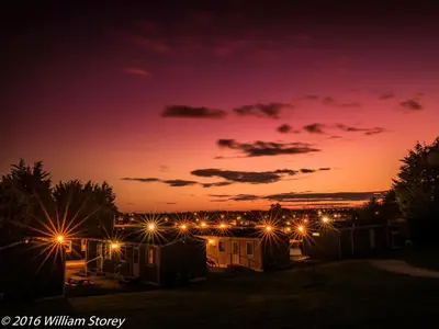 a view of a city at night with lights at Red Deer Village Holiday Park - 3 Bedroom, Self-Catering Chalet in Steps