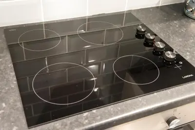 a stove top with circles on it in a kitchen at Two Bed Stylish Apartment in Heart of West End in Glasgow
