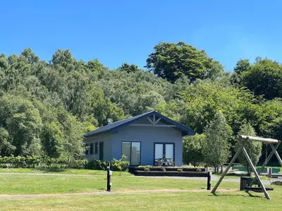 a tiny house in a park with a playground at Spacious 3-Bedroom Chalet on Country Estate near Glasgow - sleeps 6 in Glasgow