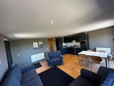 a living room with blue chairs and a white table at Spacious 3-Bedroom Chalet on Country Estate near Glasgow - sleeps 6 in Glasgow