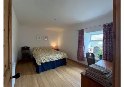 a bedroom with a bed and a window at Willow Cottage, Gilchristland Organic Farm in Closeburn