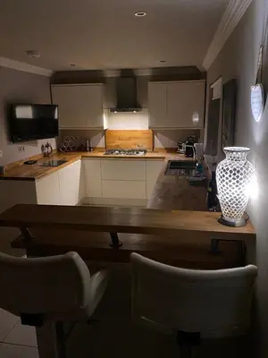 a kitchen with a table with a vase on it at Woodhead view in Kirkintilloch