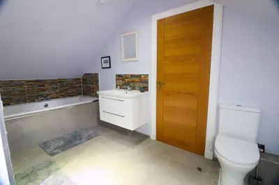 a bathroom with a toilet and a sink and a tub at Woodhead view in Kirkintilloch
