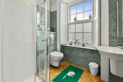 a bathroom with a toilet and a sink and a shower at Seaside Place, Aberdour in Aberdour