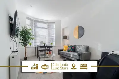 a living room with a couch and a table at Dyke Apartment in Bailleston