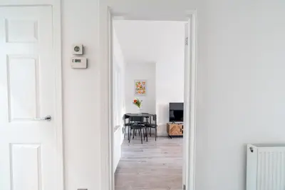 a door leading into a dining room with a table at Locksley House in Knightswood