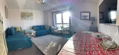 a living room with a blue couch and a table at Facing Glasgow Green spacious Apartment Free parking in Glasgow