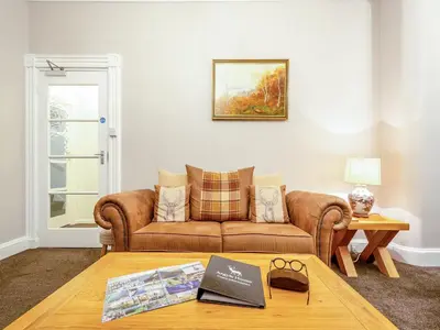 a living room with a couch and a table at Argyle House in Rothesay