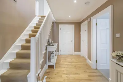 a staircase in a home with a white stair case at Springfield Lodge Bed and Breakfast in Stirling