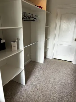 a room with a white closet with a door at 15 min drive to airport 20 min to Loch Lomond and city center in Old Kilpatrick