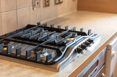 a stove top oven sitting in a kitchen at Cromwell Corner - Donnini Apartments in Ayr