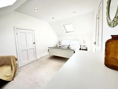 a bedroom with white walls and a white door at Luxury Smugglers Cottage in the Heart of Inveraray Sleeps 4 in 2 Bedrooms in Inveraray