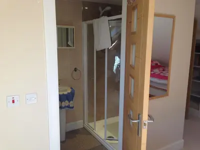 a bathroom with a shower and a glass door at Langside in Stirling
