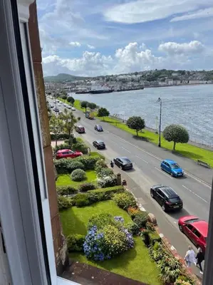 a view from a window of a street with cars at Bellevue Bute, Luxury 2 bedroom sea view flat in Rothesay