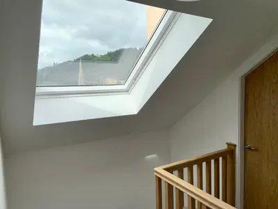 a skylight in a room with a staircase with a window at Stunning Apartment in Callander in Callander