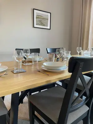 a wooden table with wine glasses on top of it at Stunning Apartment in Callander in Callander