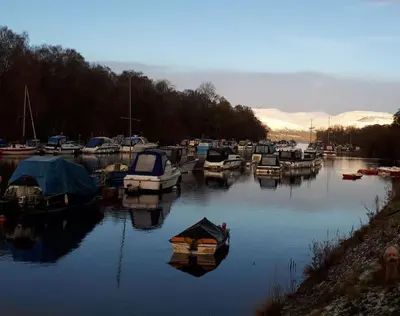 a bunch of boats are docked in a harbor at Spacious 2 bedroom house on the edge of Balloch in Balloch