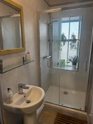 a bathroom with a shower and a sink and a shower at Beautiful traditional top floor flat in the center of Largs in Largs