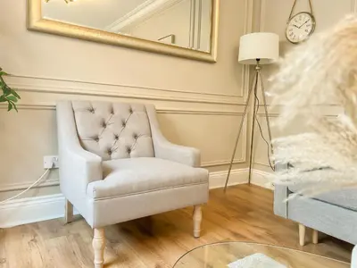 a living room with a chair and a lamp at Cozy 1 bed Blythswood Apartment in Glasgow