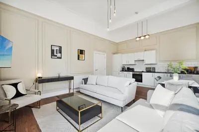 a living room with a white couch and a table at (G1) Elegant 2 bed Blythswood Apartment in Glasgow