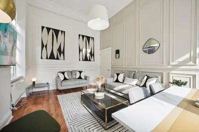 a living room with a couch and a table at (G3) Grand 2 bed Blythswood Apartment in Glasgow