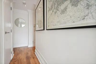 a hallway with two framed maps on the wall at (G3) Grand 2 bed Blythswood Apartment in Glasgow
