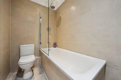 a bathroom with a toilet and a bath tub at (G3) Grand 2 bed Blythswood Apartment in Glasgow