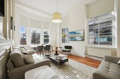 a living room with a couch and a table at (G3) Grand 2 bed Blythswood Apartment in Glasgow