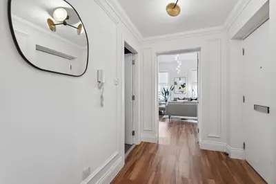 a hallway with a mirror and a living room at (G5) Grand 1 bed Blythswood Apartment in Glasgow