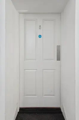 a white door with a blue button on it at (G5) Grand 1 bed Blythswood Apartment in Glasgow