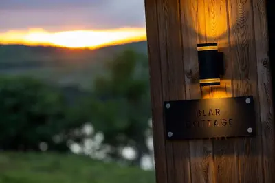 a sign on a wooden post with the words bar cottage at Blar Cottage (Private Sauna + Fast Starlink Wifi) in Hayfield