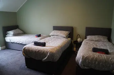 two beds in a room with two beds sidx sidx sidx sidx at Garnock 1 in Beith