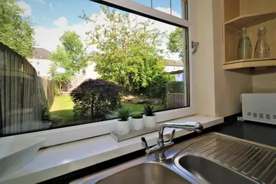 a kitchen sink and a window with a view of a yard at Signature - Lincoln View in Knightswood
