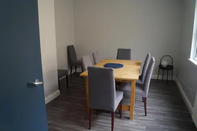 a dining room with a wooden table and chairs at Garnock 2 in Beith