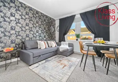 a living room with a couch and a table at Uddingston Apartment by Klass Living in Uddingston