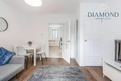 a living room with a couch and a table at FOUNDRY - 2 Bedrooms, Fully Equipped, Free Parking, WiFi, FAVOURITE for Contractors, Long Stays Welcome, Food, Bars, Shops by Diamond Short Lets in Dunfermline