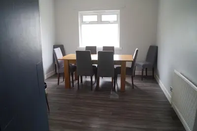 a dining room with a table and chairs at Garnock 3 in Beith