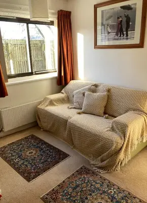 a living room with a couch and a window at Aquila Retreats in Comrie